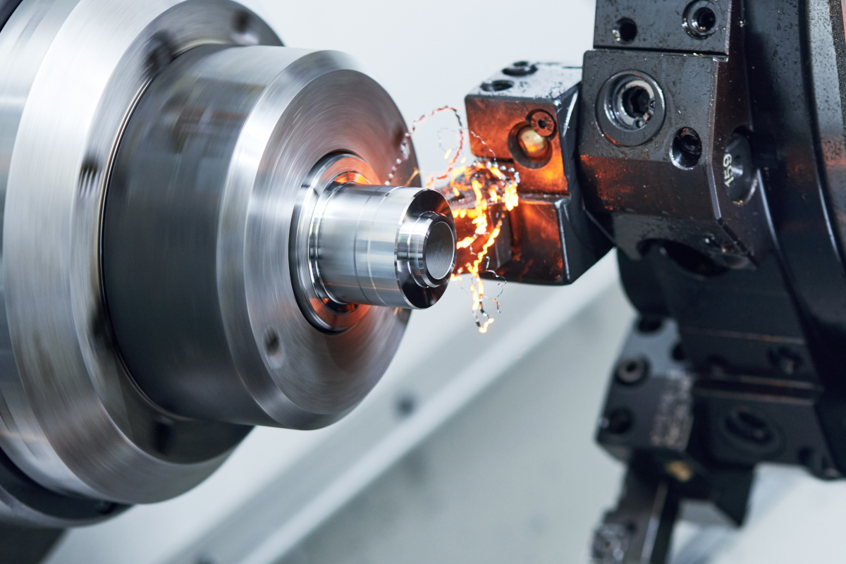 metalworking industry. cutting tool processing steel metal detail on turning lathe machine in workshop