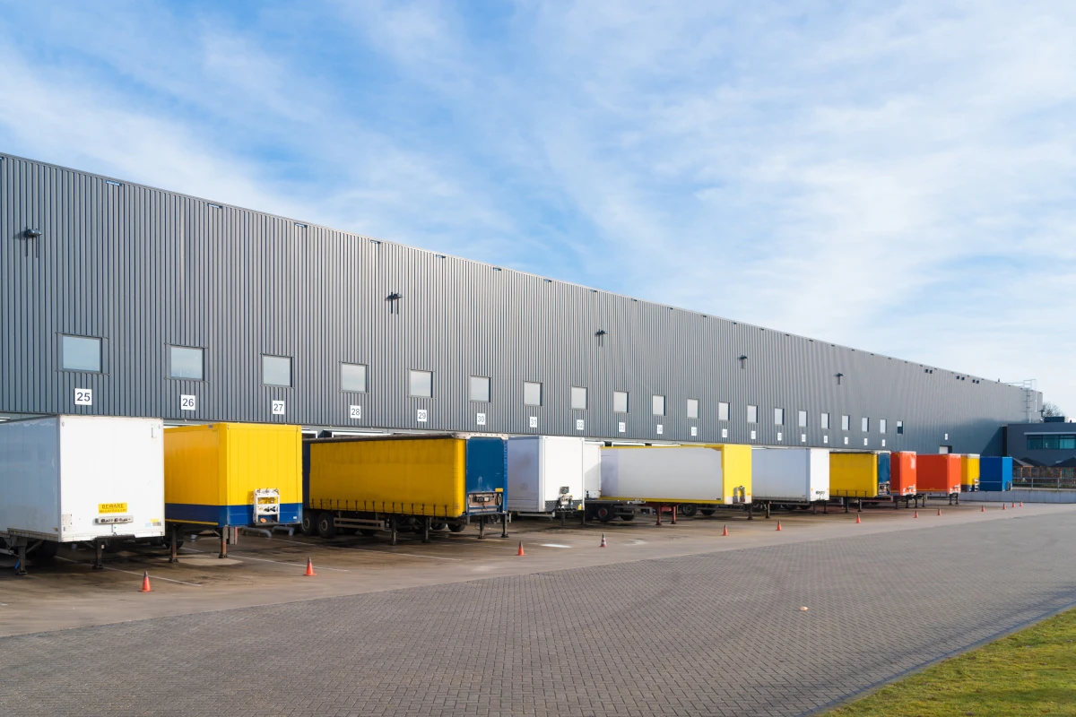 large commercial warehouse with trailers in front
